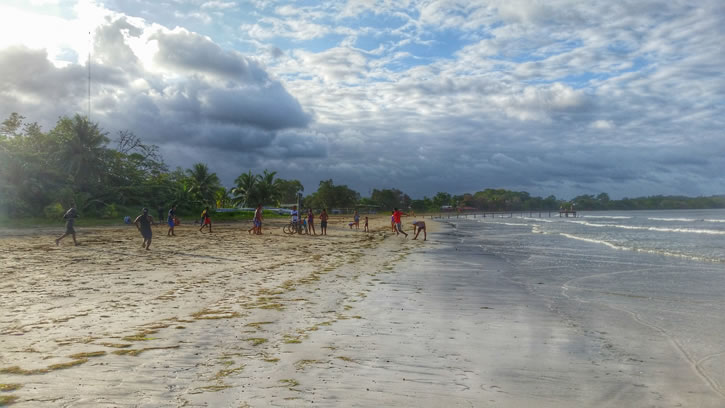 Local kids playing soccer on the sand at Bocas' Town Beach.